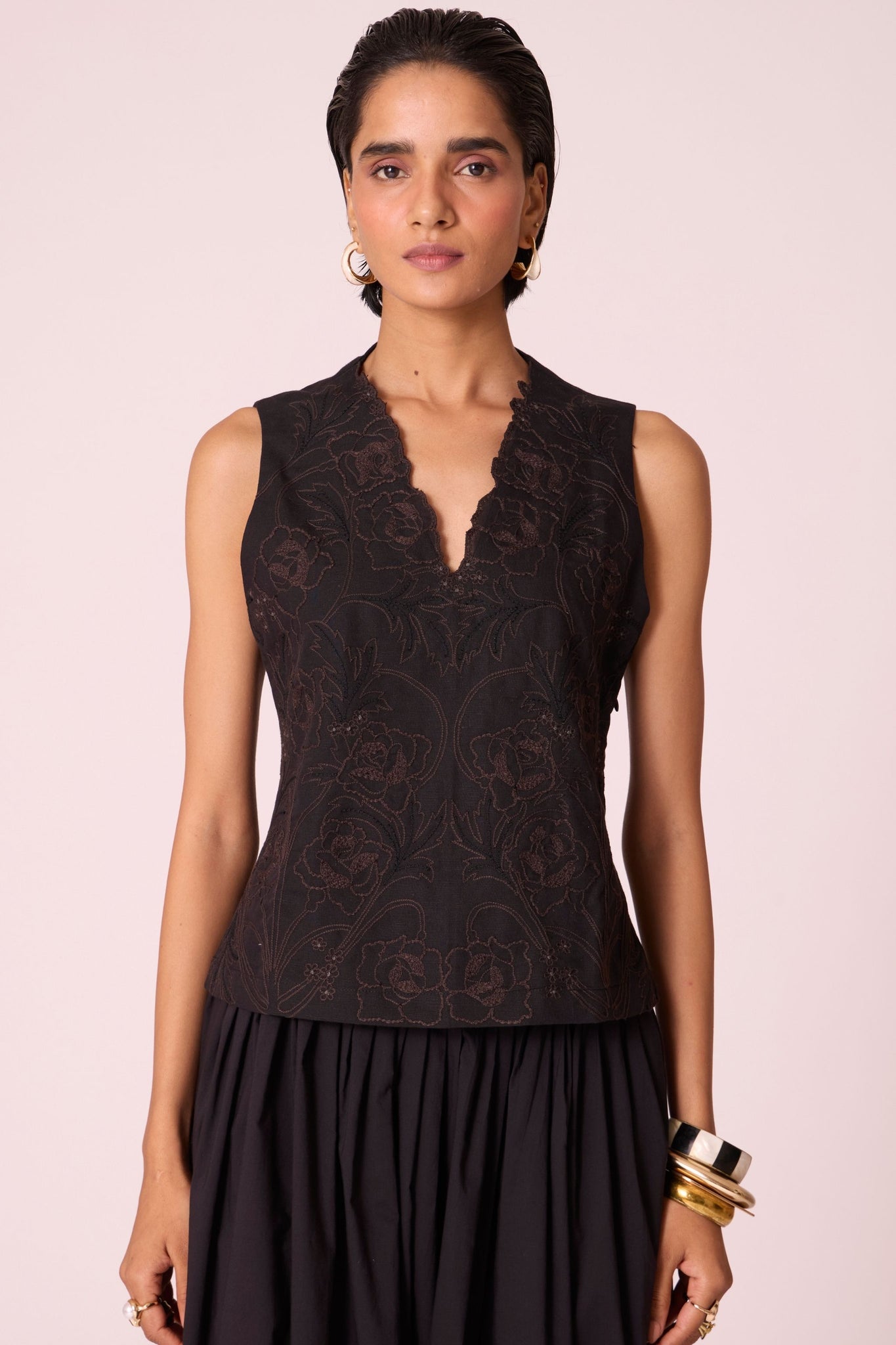 Black linen-cotton sleeveless top with hand-embroidered bodice, V-neckline, and side zip fastening.