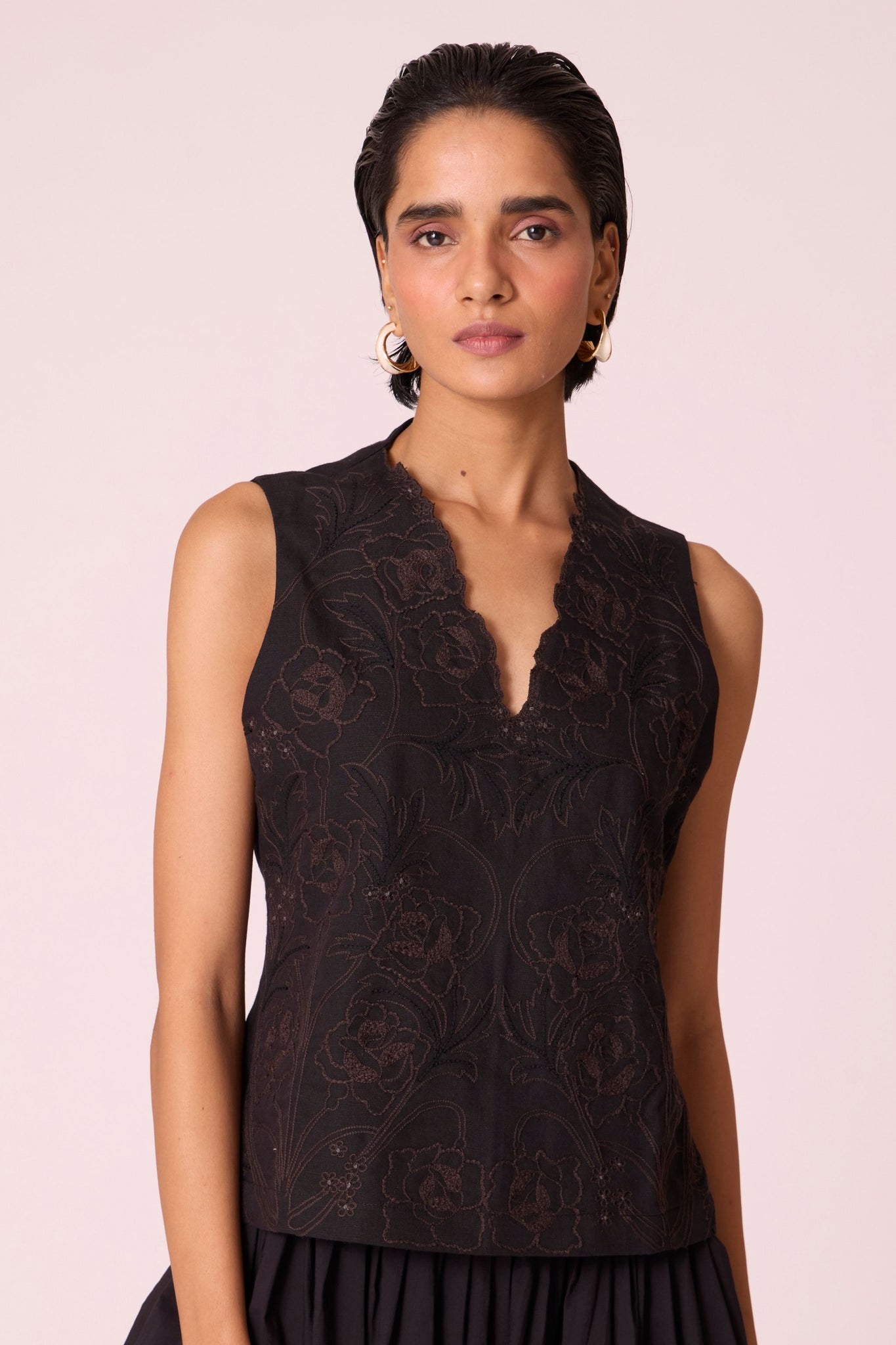 Black linen-cotton sleeveless top with hand-embroidered bodice, V-neckline, and side zip fastening.