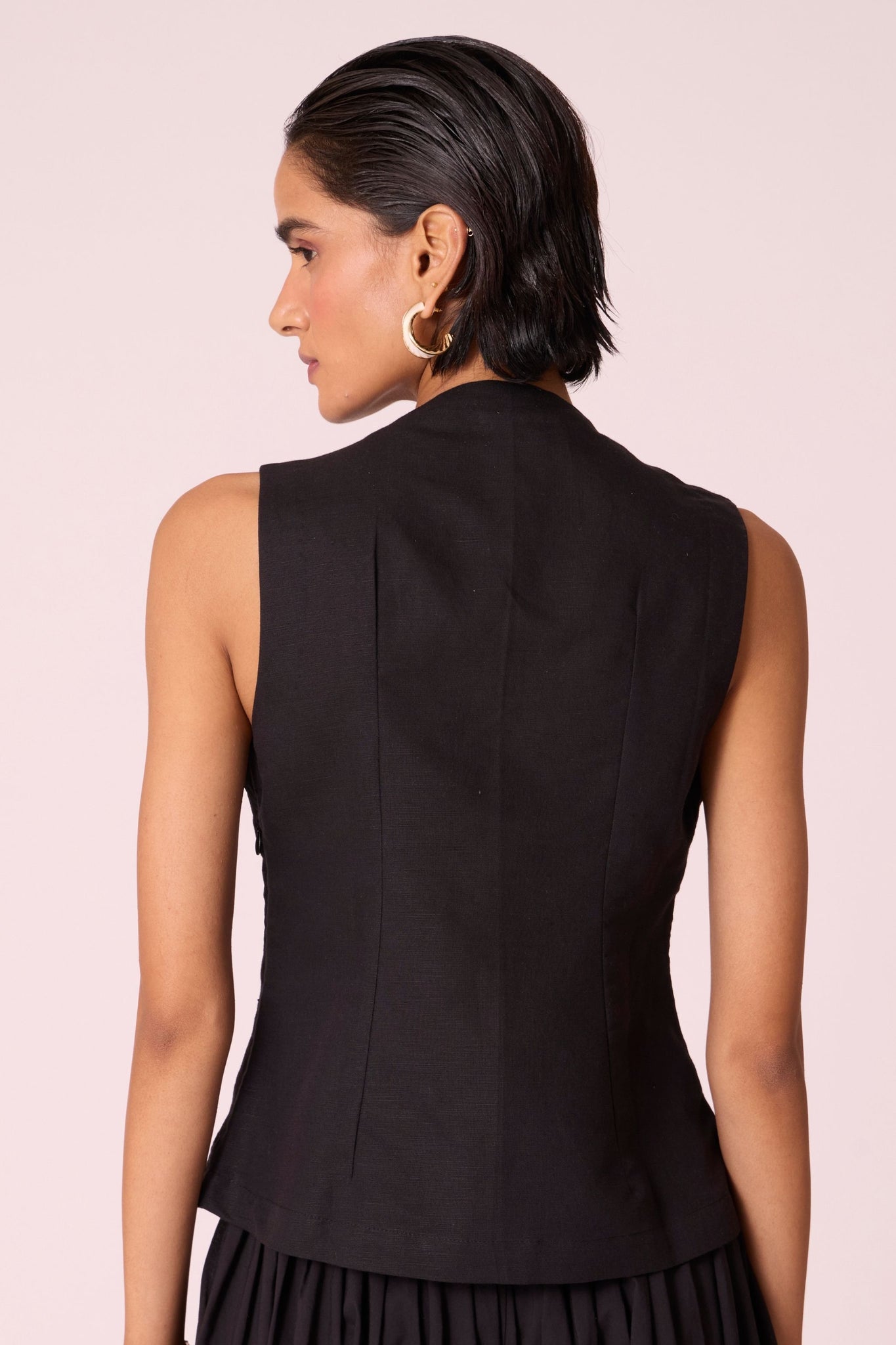 Black linen-cotton sleeveless top with hand-embroidered bodice, V-neckline, and side zip fastening.