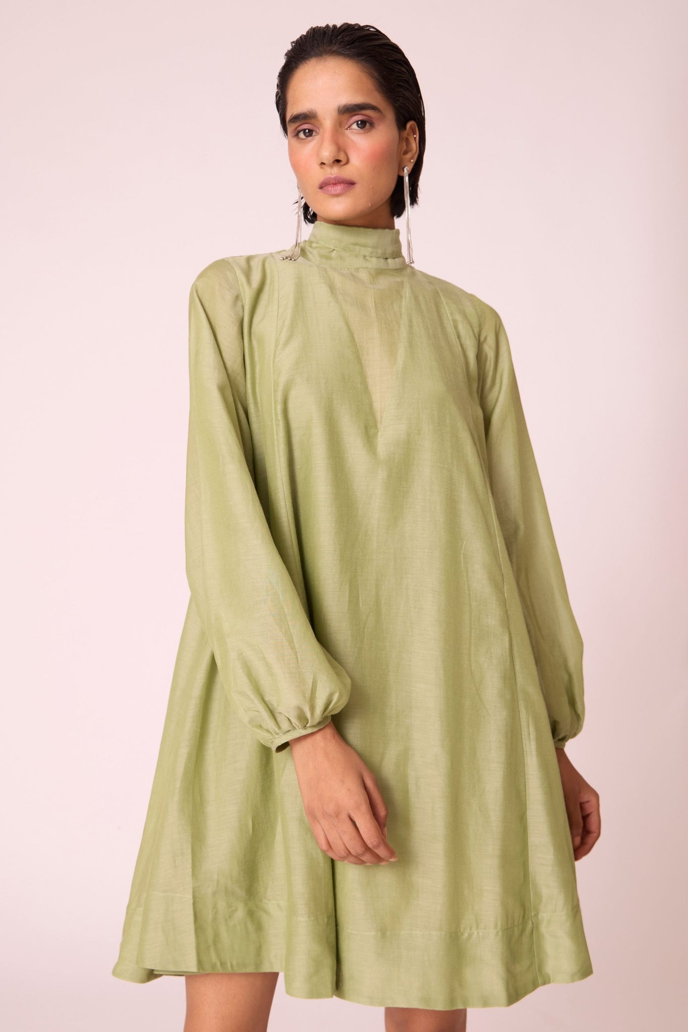 Green silk-cotton panelled short dress with halter neck, back tie, bishop sleeves, and lined body.