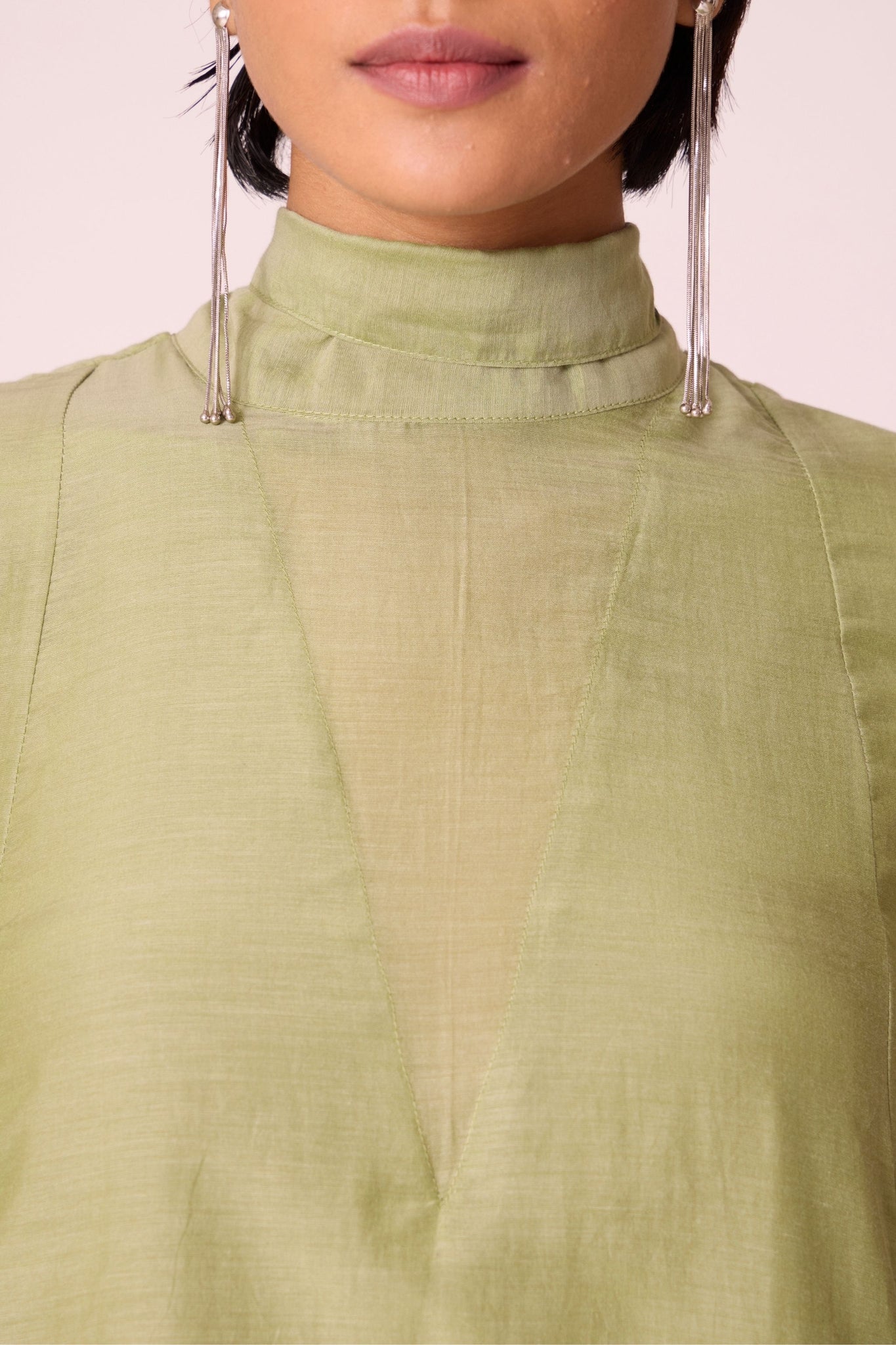 Green silk-cotton panelled short dress with halter neck, back tie, bishop sleeves, and lined body.