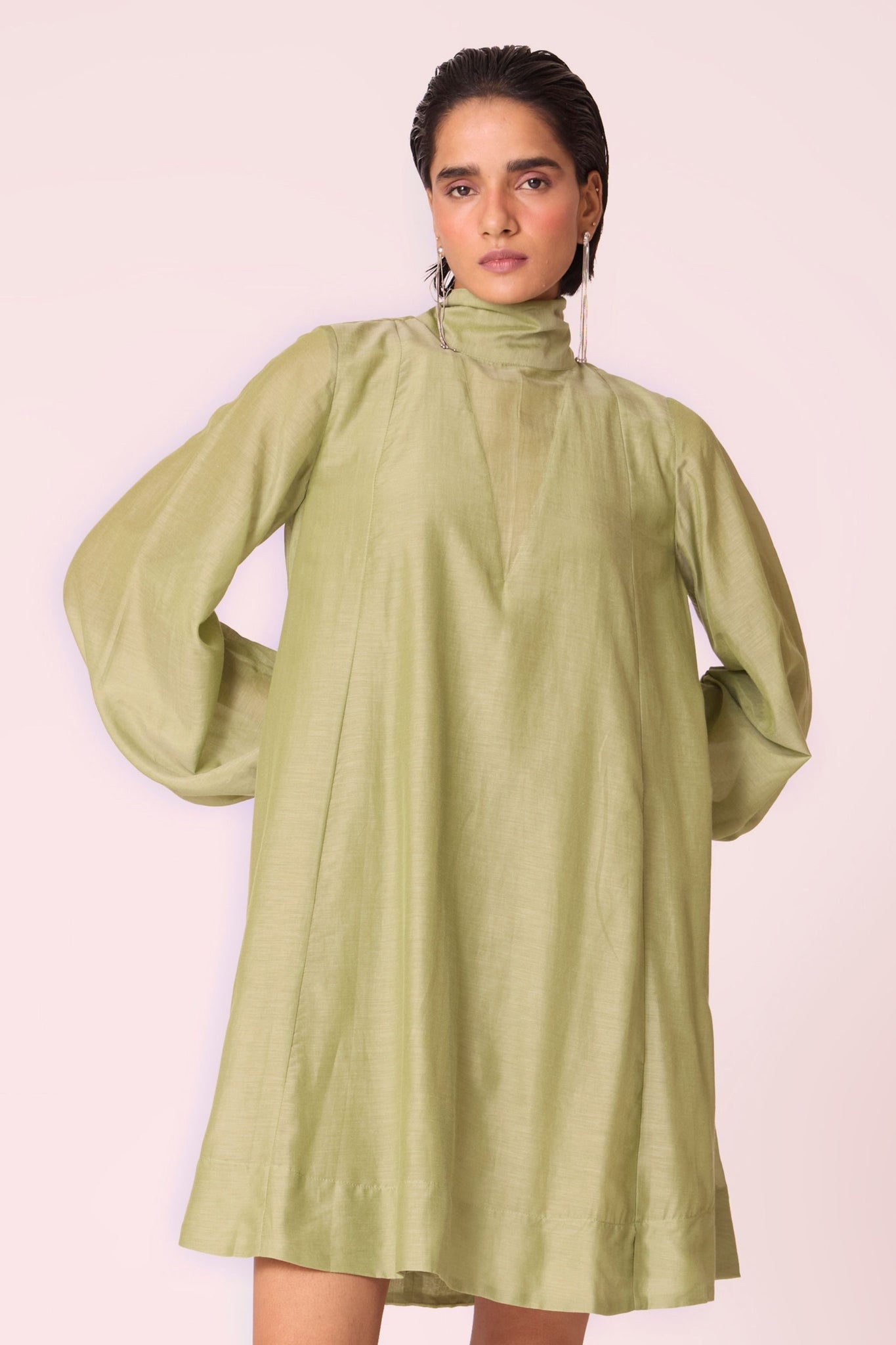 Green silk-cotton panelled short dress with halter neck, back tie, bishop sleeves, and lined body.