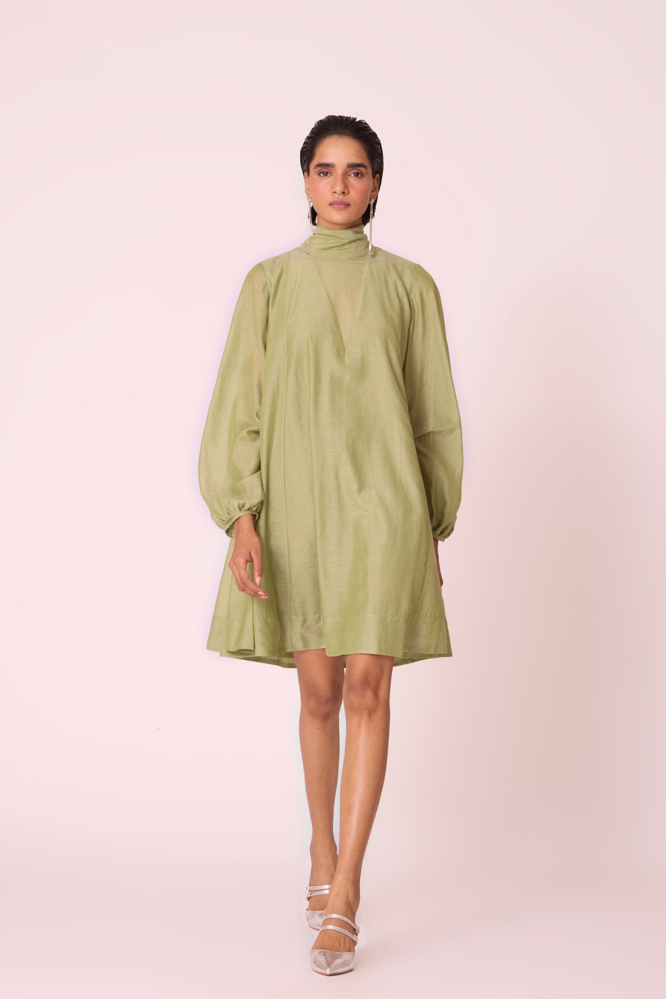 Green silk-cotton panelled short dress with halter neck, back tie, bishop sleeves, and lined body.