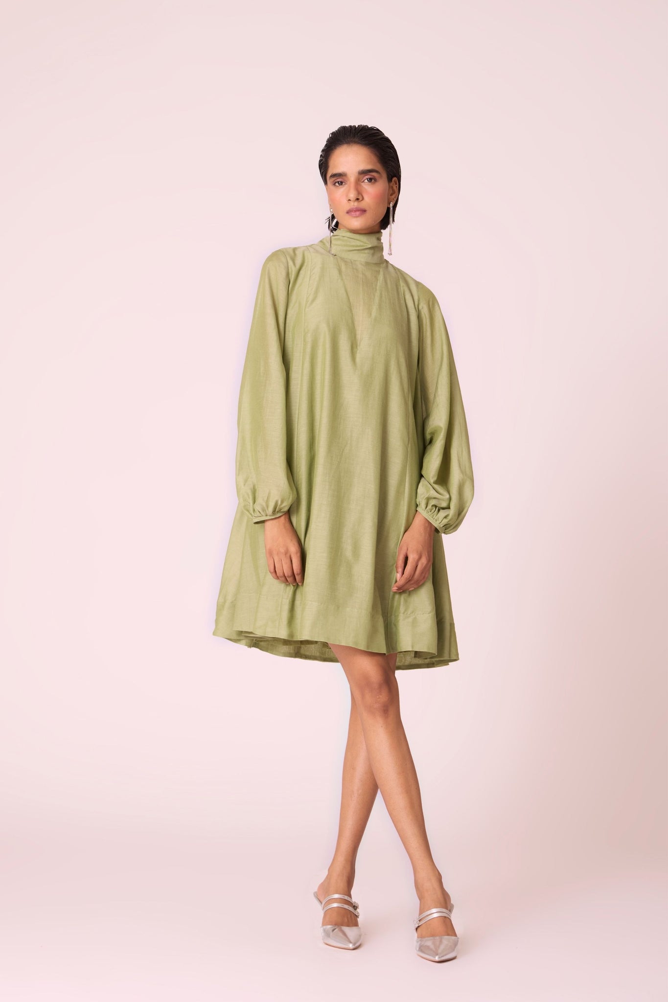 Green silk-cotton panelled short dress with halter neck, back tie, bishop sleeves, and lined body.