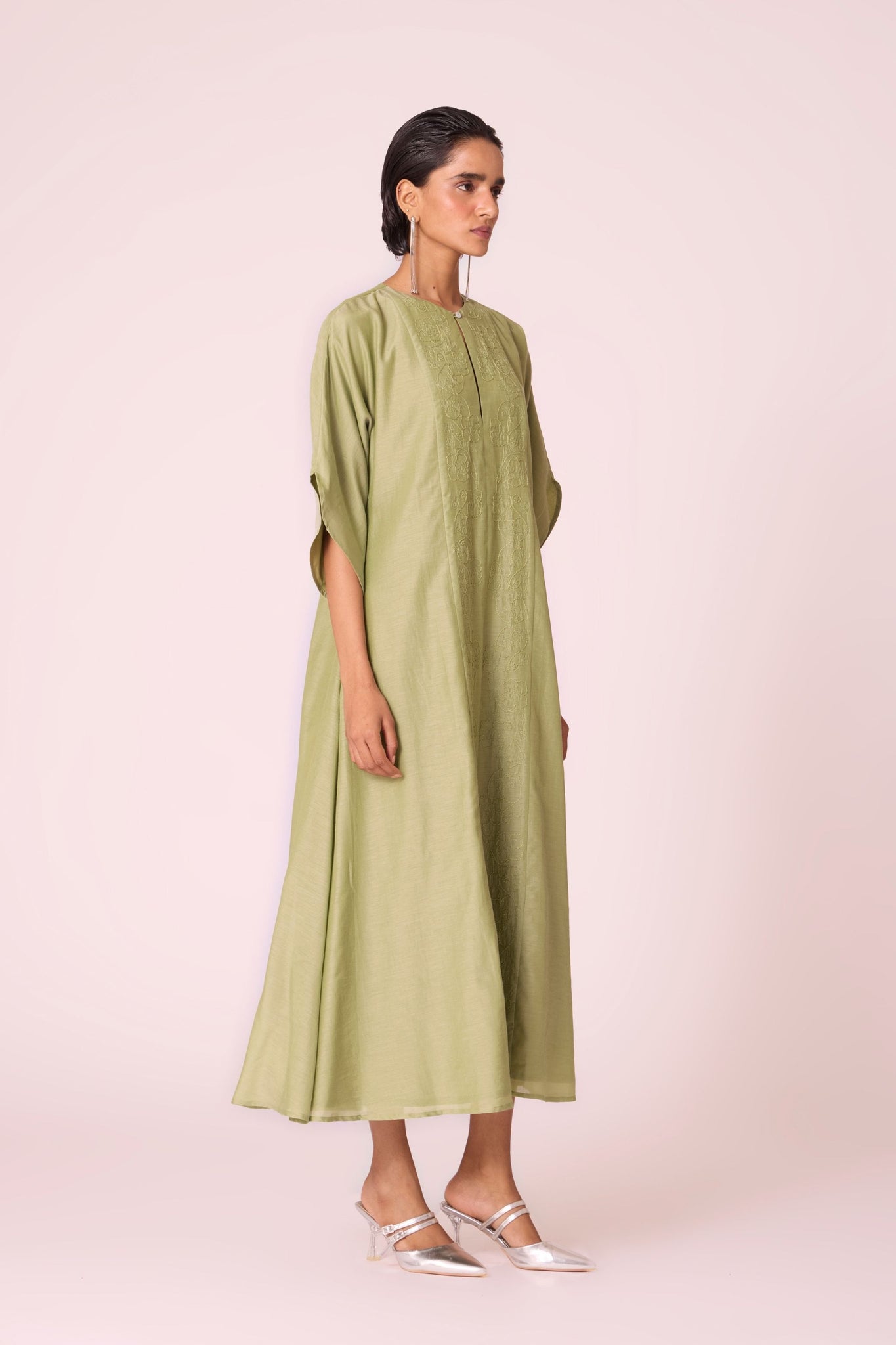 Green silk-cotton dress with hand-embroidered keyhole neckline, drop sleeves, full lining, and in-seam pockets.