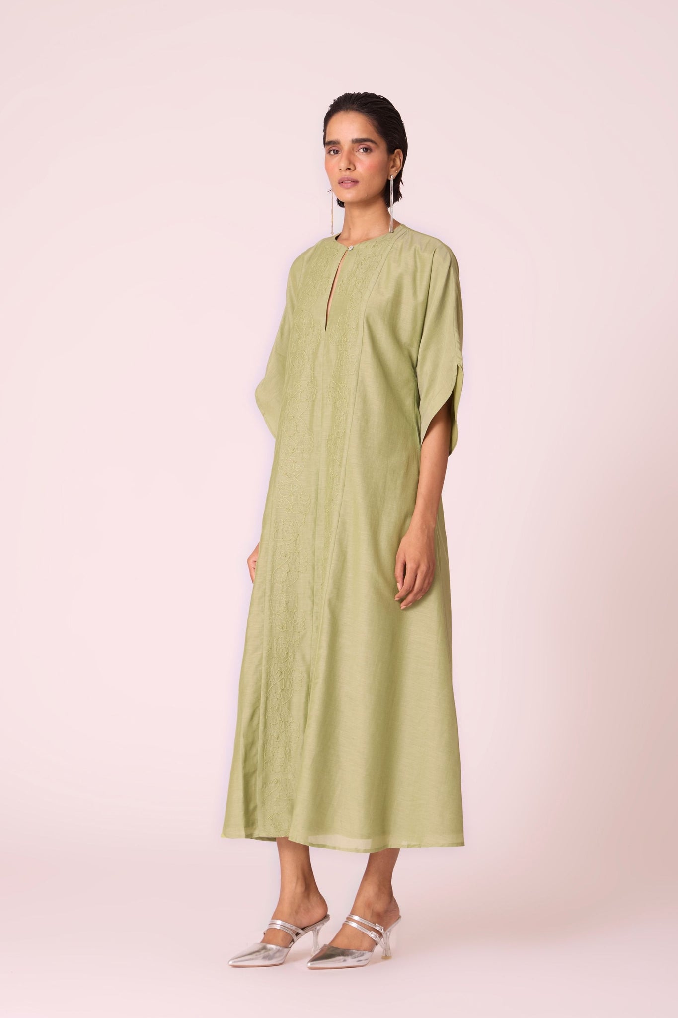 Green silk-cotton dress with hand-embroidered keyhole neckline, drop sleeves, full lining, and in-seam pockets.