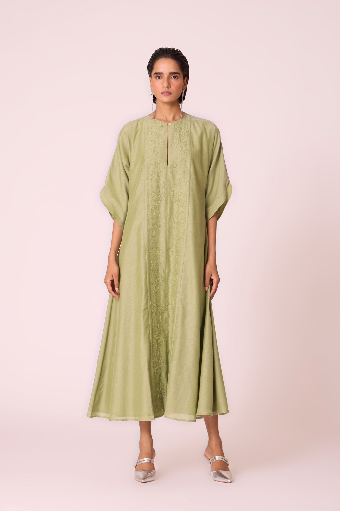 Green silk-cotton dress with hand-embroidered keyhole neckline, drop sleeves, full lining, and in-seam pockets.