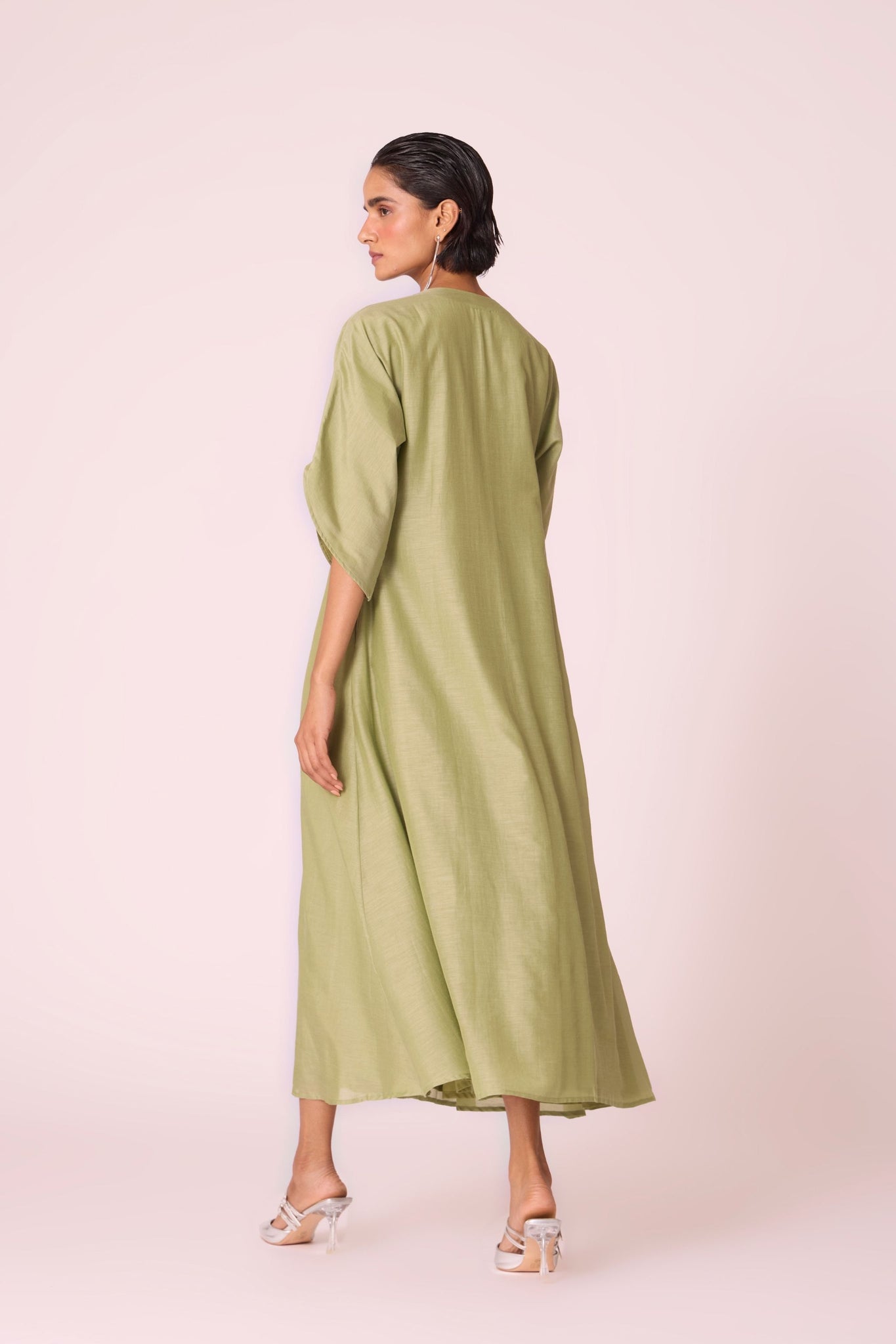 Green silk-cotton dress with hand-embroidered keyhole neckline, drop sleeves, full lining, and in-seam pockets.