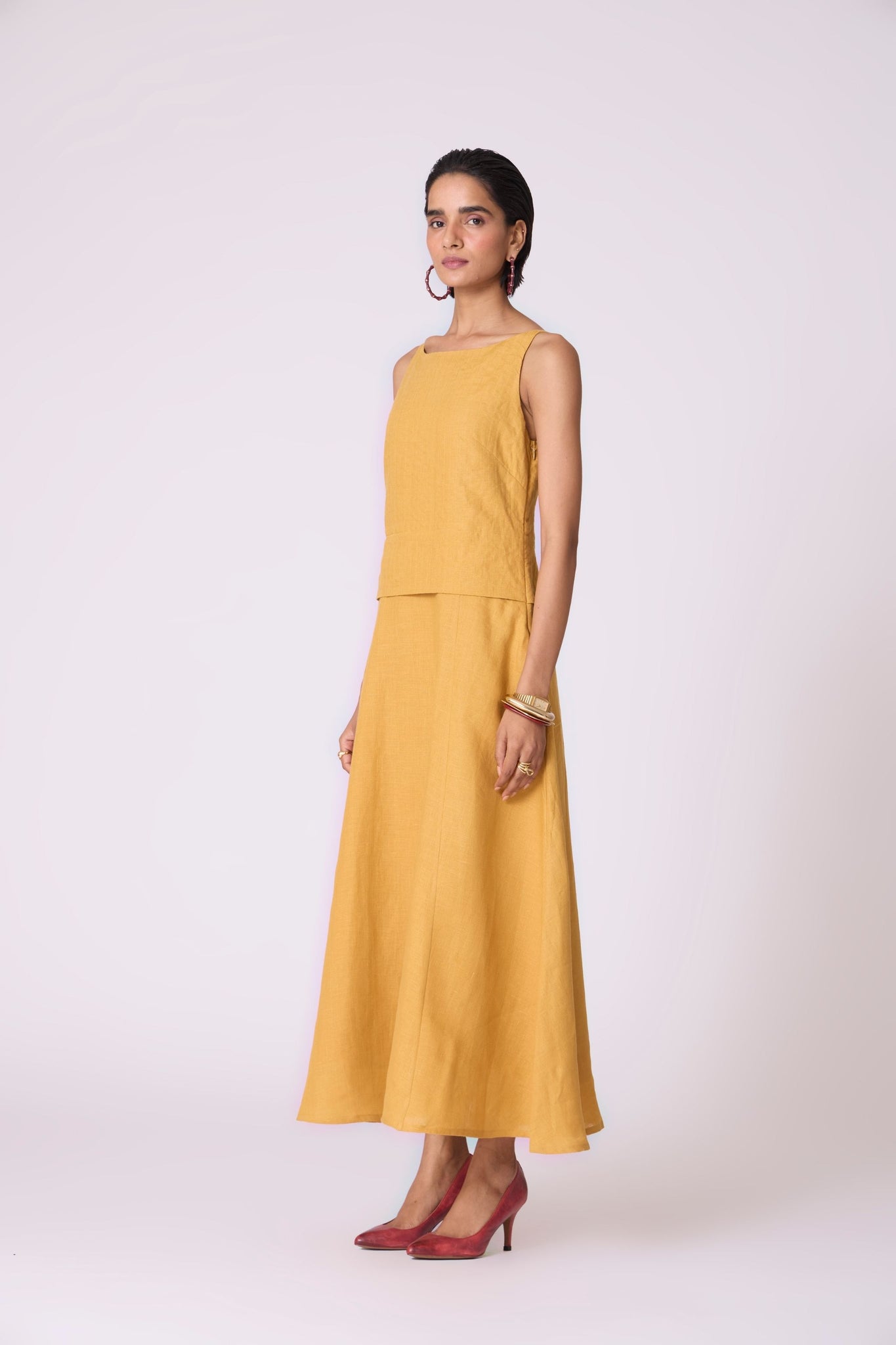 Yellow linen panelled dress with quilted low-waist yoke, paneled hemline, full lining, and in-seam pockets.