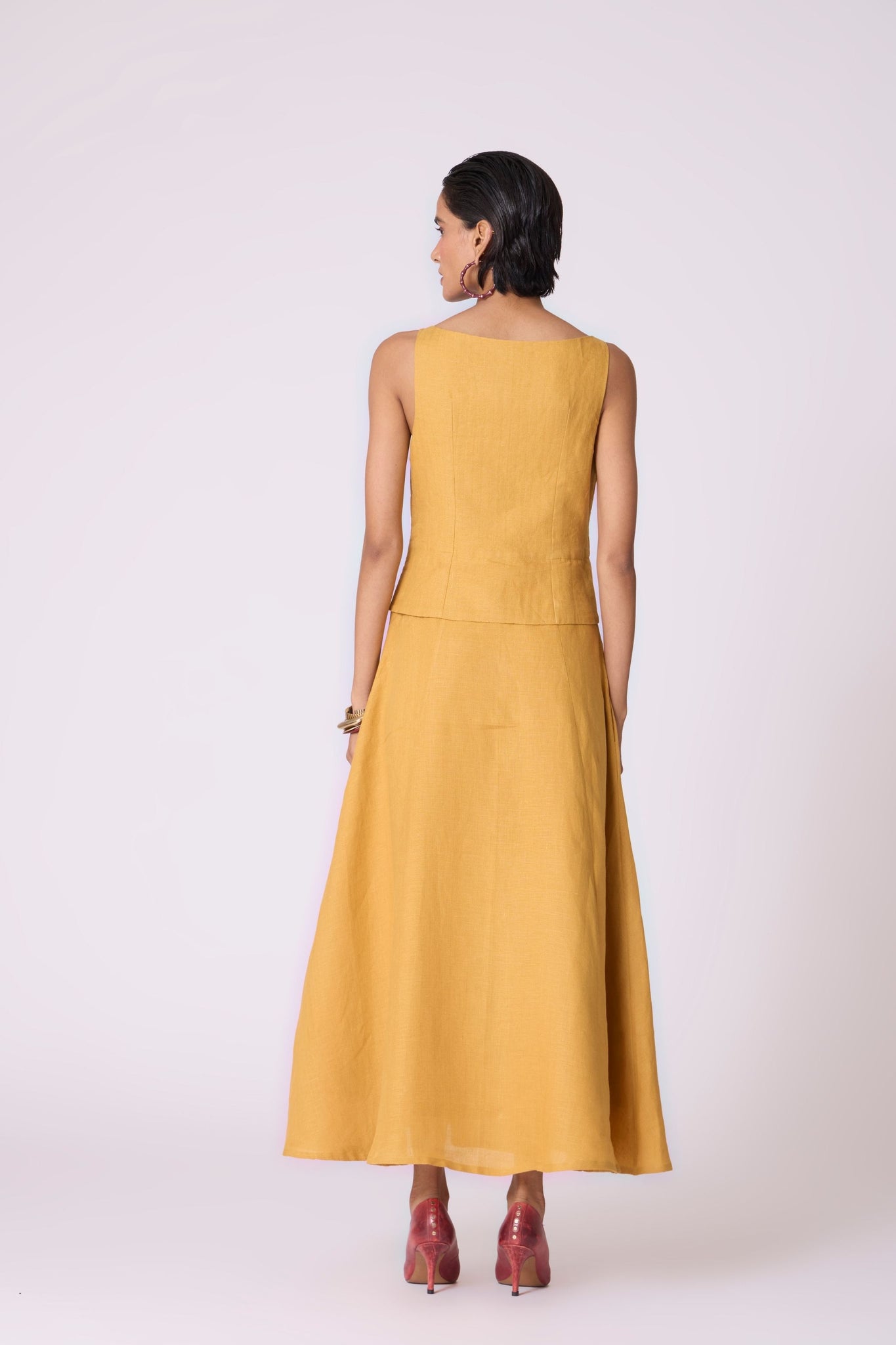 Yellow linen panelled dress with quilted low-waist yoke, paneled hemline, full lining, and in-seam pockets.