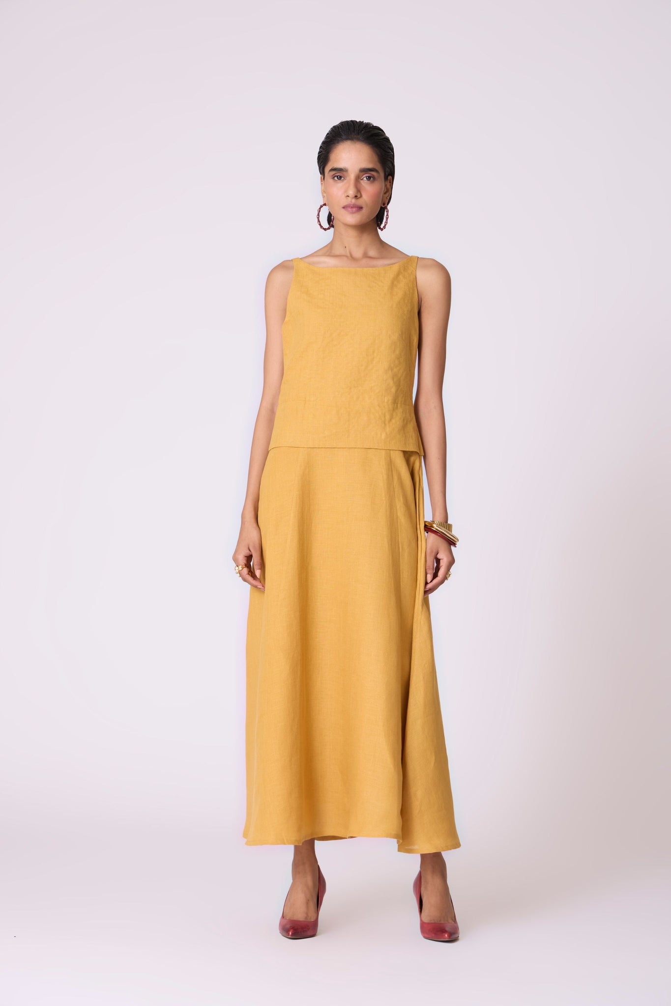 Yellow linen panelled dress with quilted low-waist yoke, paneled hemline, full lining, and in-seam pockets.