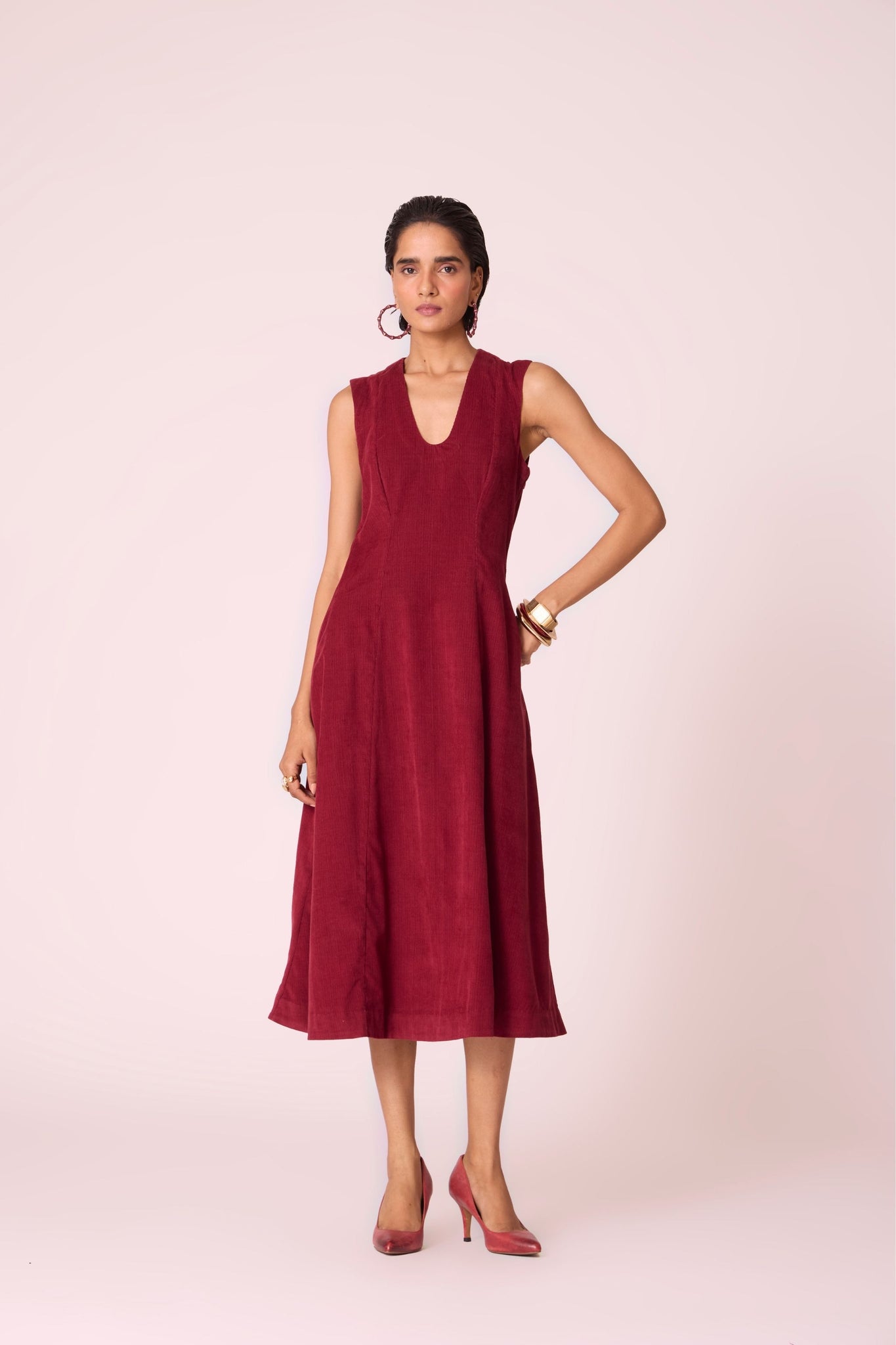Cherry needlecord fit-and-flare midi dress with soft V-neckline, panel detailing, side zip, and in-seam pockets.
