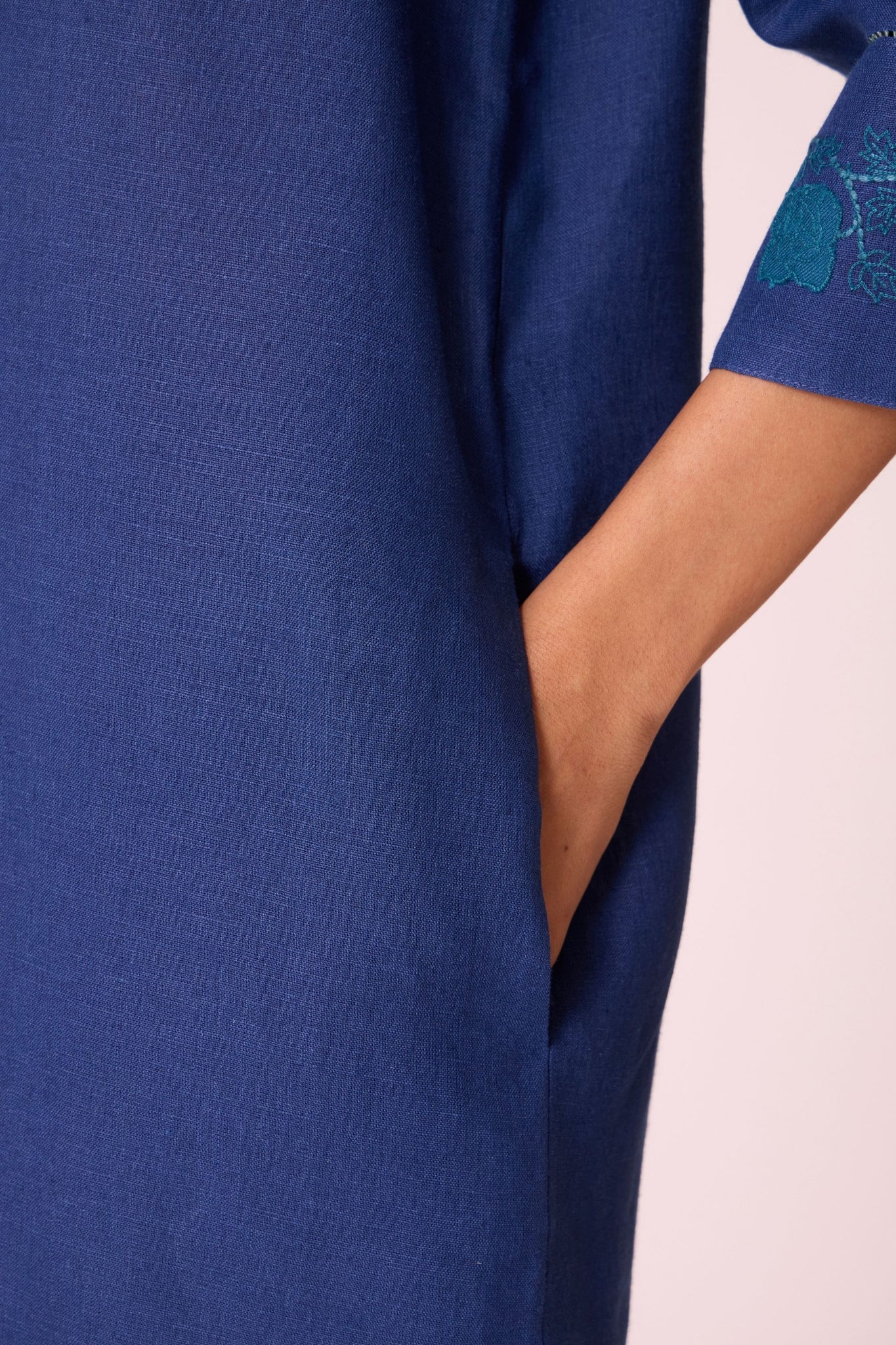 Ink blue linen tunic set with hand-embroidered 3/4 sleeves, back button tunic, and slim-fit side-zip pants.