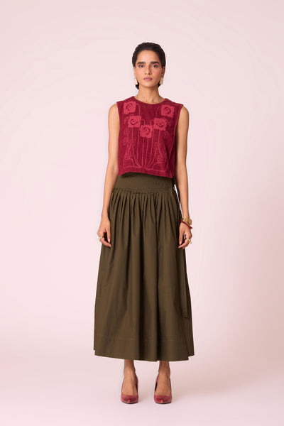 Green cotton poplin pleated midi wrap skirt with adjustable wrap fastening.
