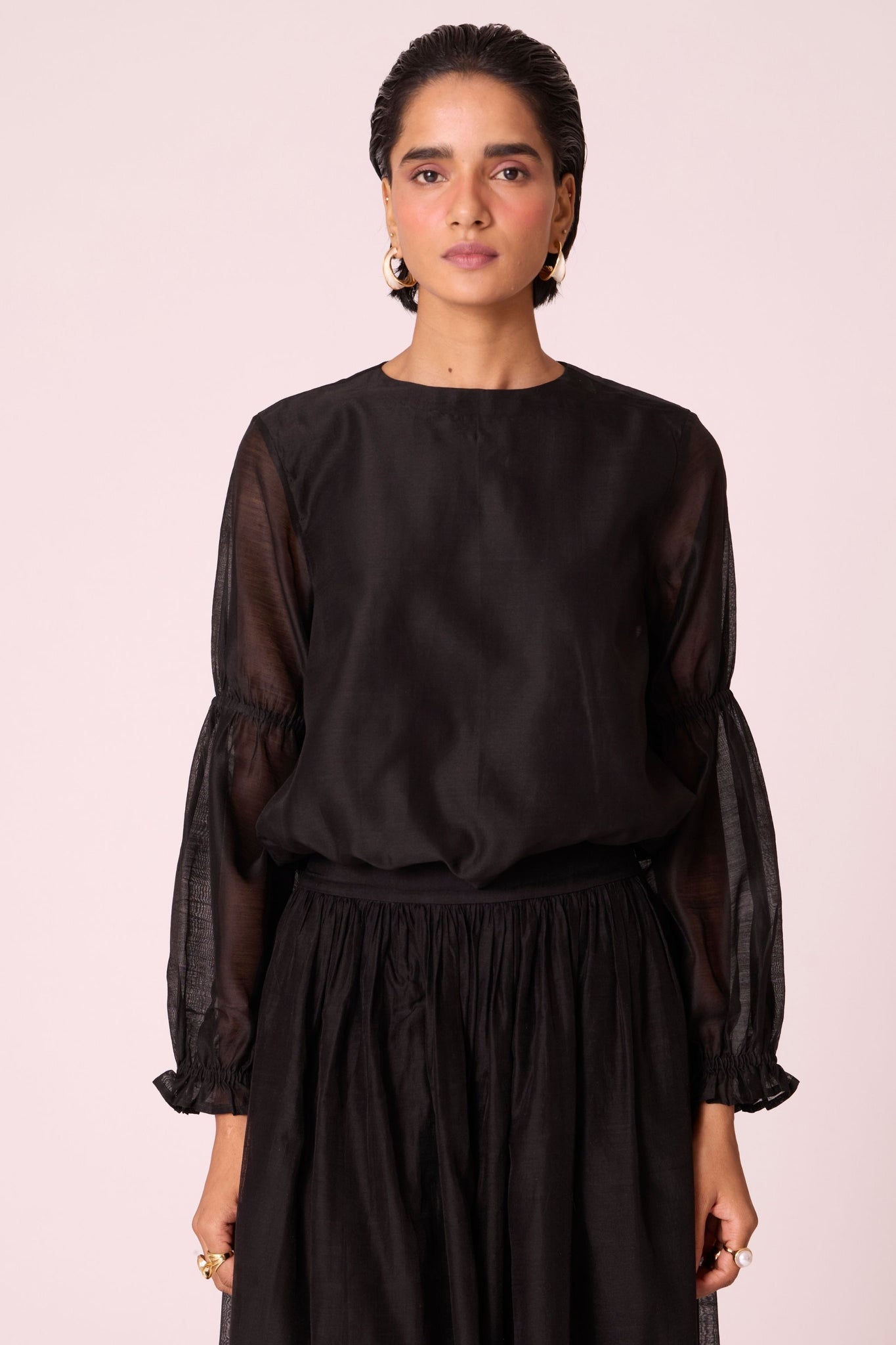 Black handwoven Chanderi top with drawstring waist, back button fastening, and elasticated sleeve details.