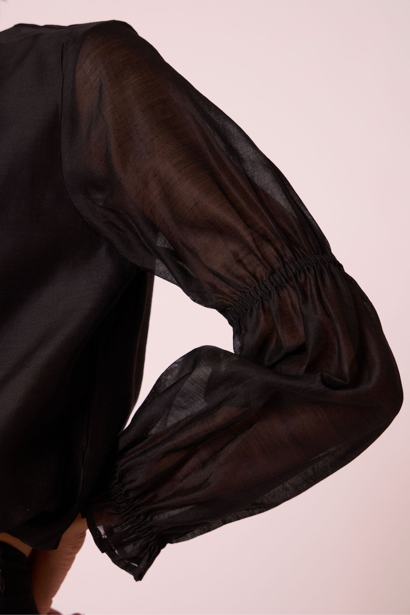 Black handwoven Chanderi top with drawstring waist, back button fastening, and elasticated sleeve details.