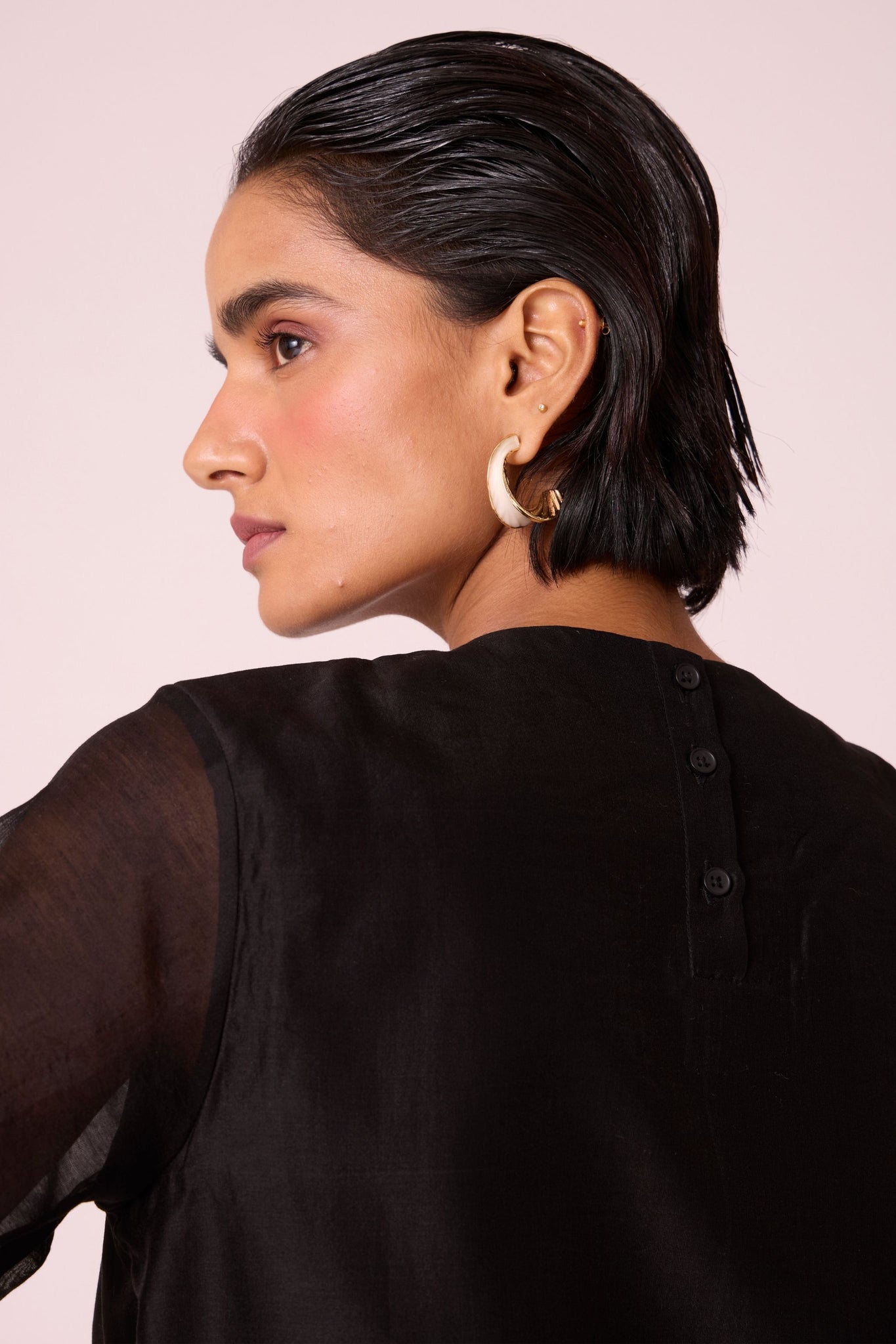 Black handwoven Chanderi top with drawstring waist, back button fastening, and elasticated sleeve details.