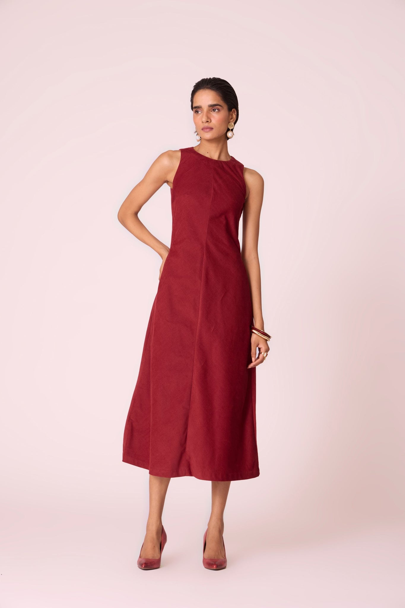 Rust needlecord midi dress with fitted bodice, back slit, back zip fastening, and in-seam pockets.