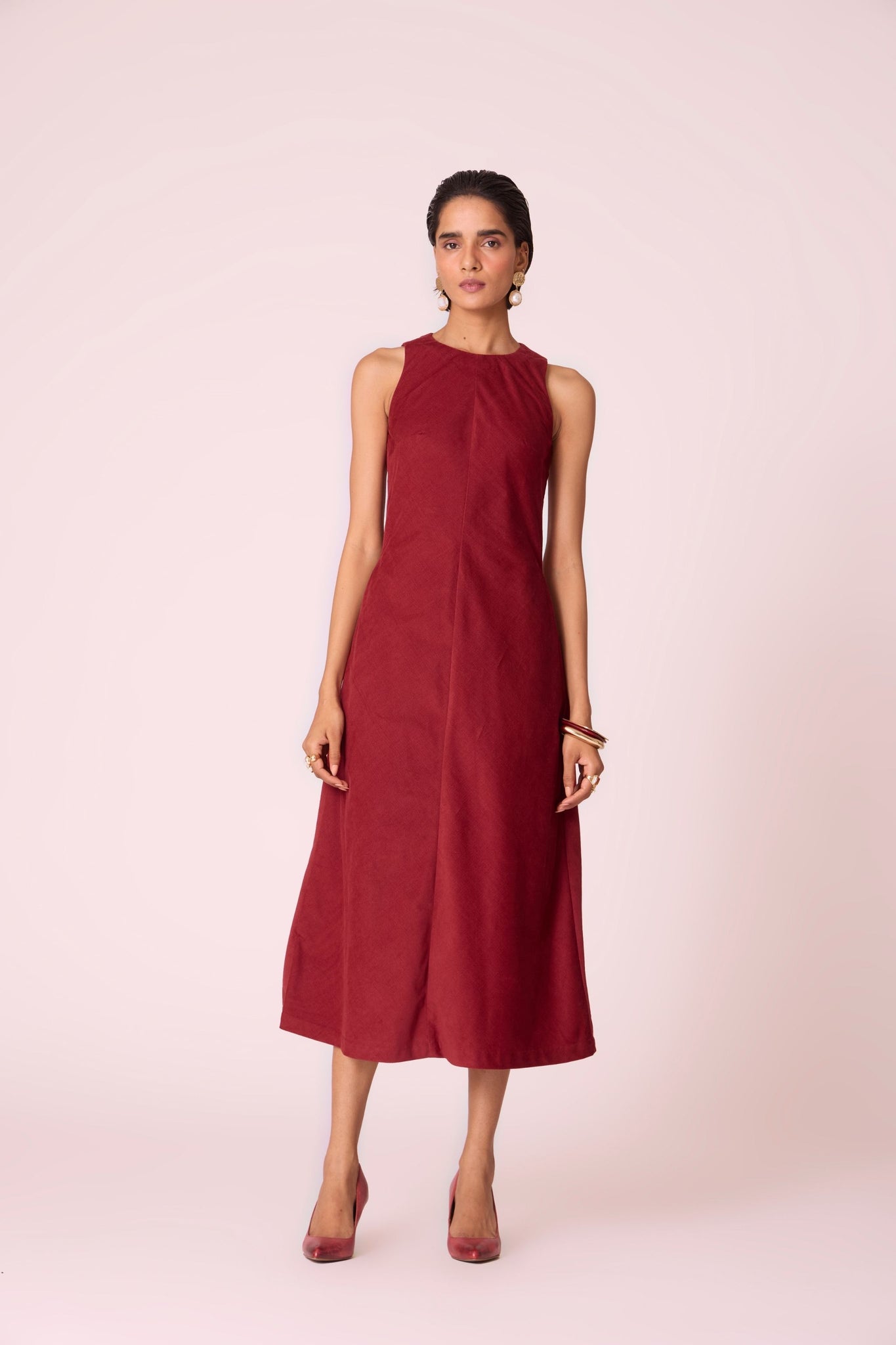 Rust needlecord midi dress with fitted bodice, back slit, back zip fastening, and in-seam pockets.