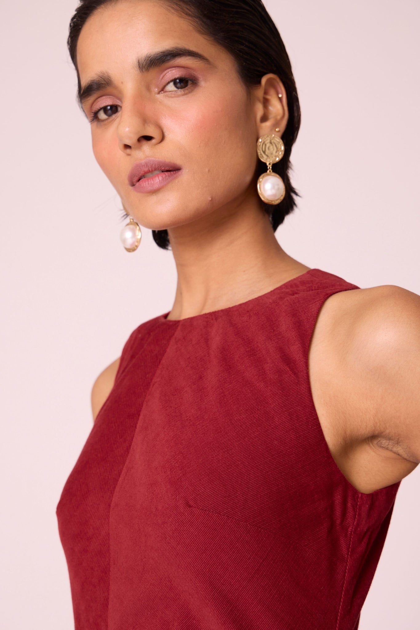 Rust needlecord midi dress with fitted bodice, back slit, back zip fastening, and in-seam pockets.