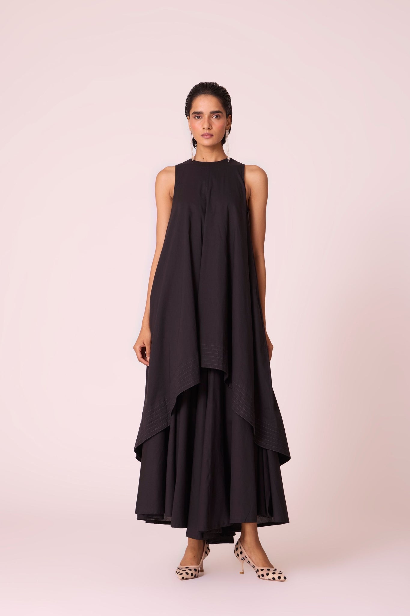 Black layered maxi dress in organic cotton cambric with in-cut shoulders and rouleau back fastening.
