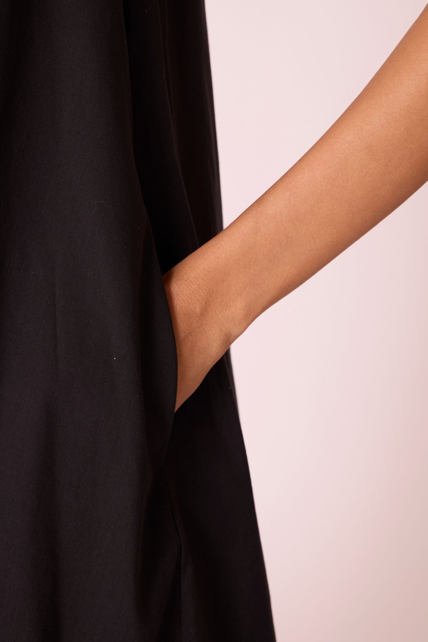 Black layered maxi dress in organic cotton cambric with in-cut shoulders and rouleau back fastening.
