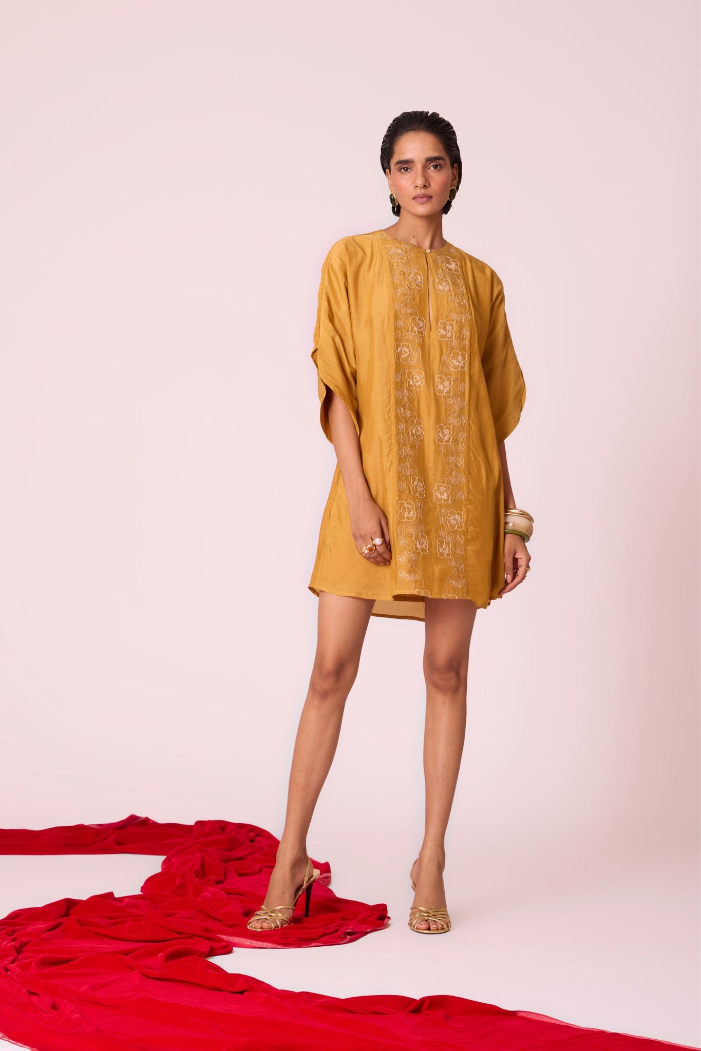 Yellow cupro dress with hand-embroidered keyhole neckline, drop sleeves, full lining, and in-seam pockets.

