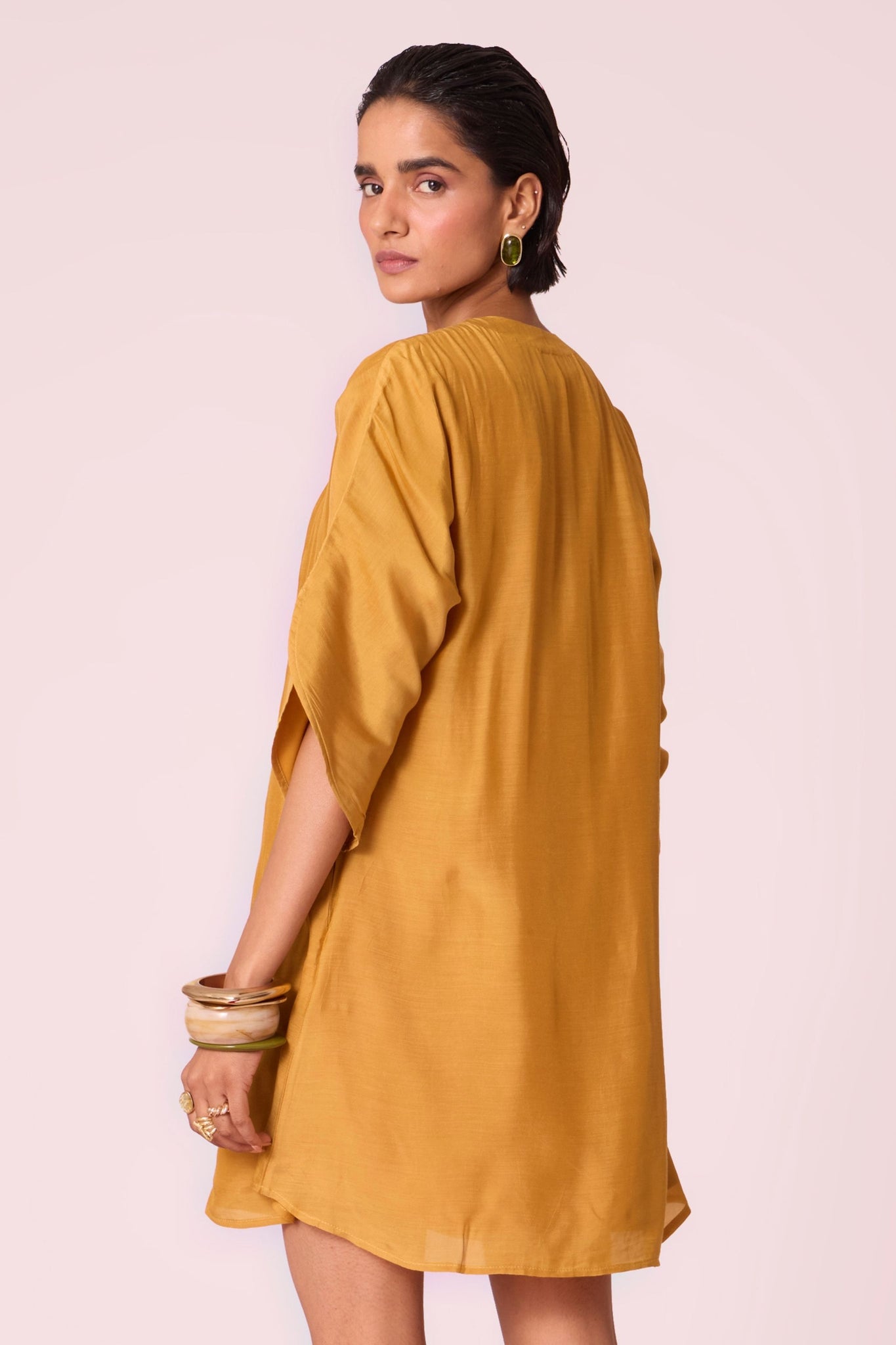 Yellow cupro dress with hand-embroidered keyhole neckline, drop sleeves, full lining, and in-seam pockets.
