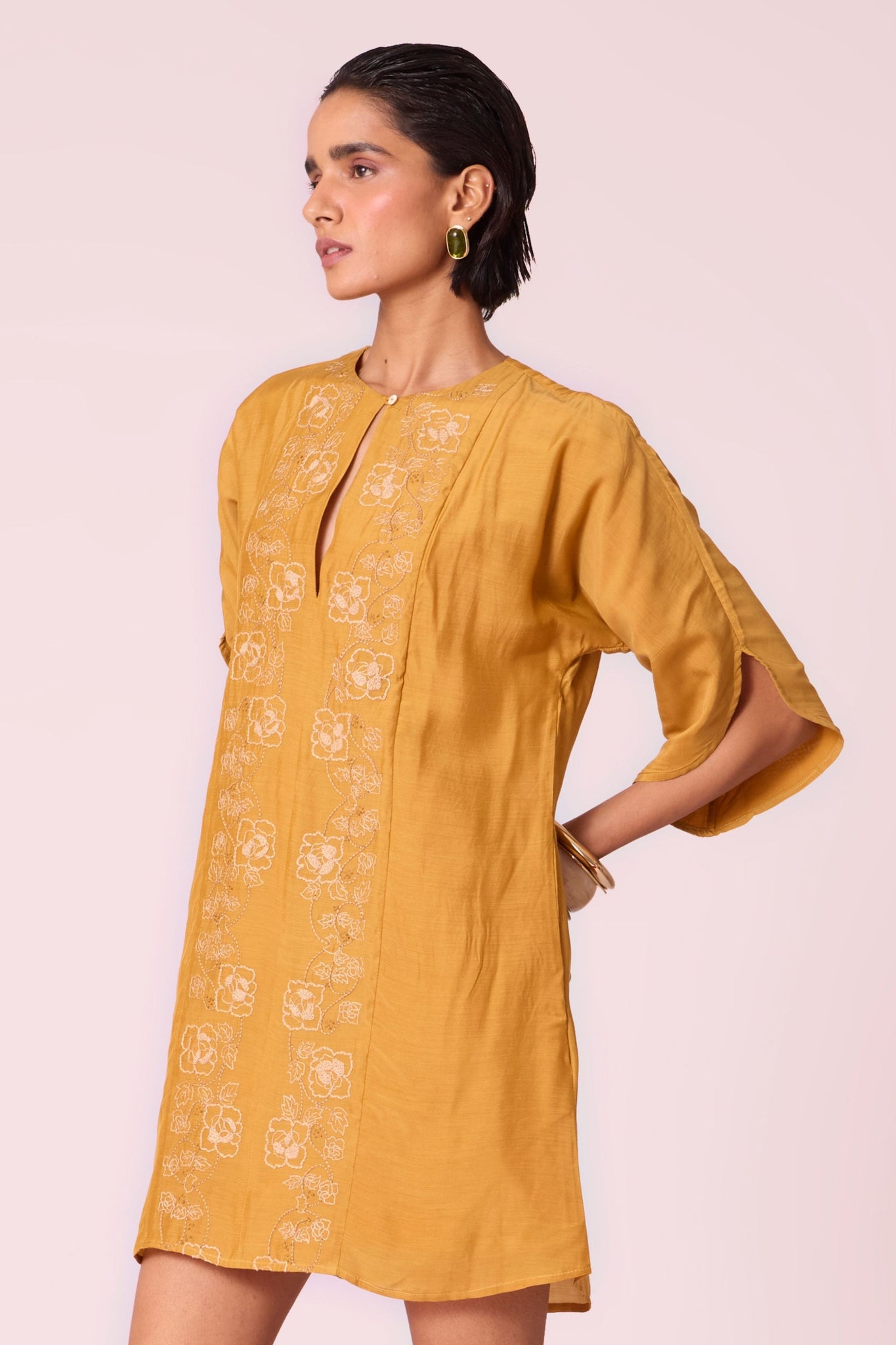 Yellow cupro dress with hand-embroidered keyhole neckline, drop sleeves, full lining, and in-seam pockets.
