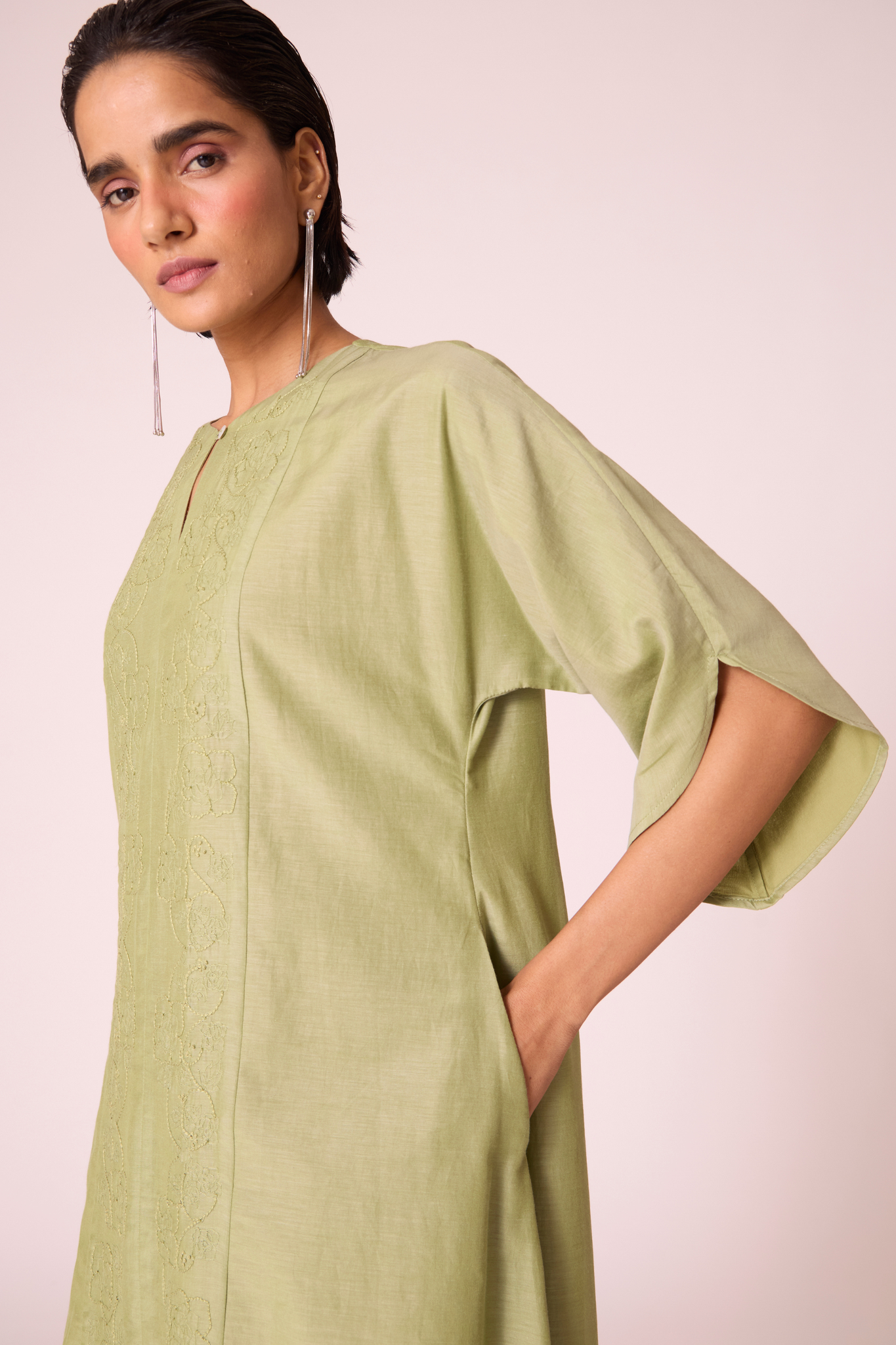 Green silk-cotton dress with hand-embroidered keyhole neckline, drop sleeves, full lining, and in-seam pockets.