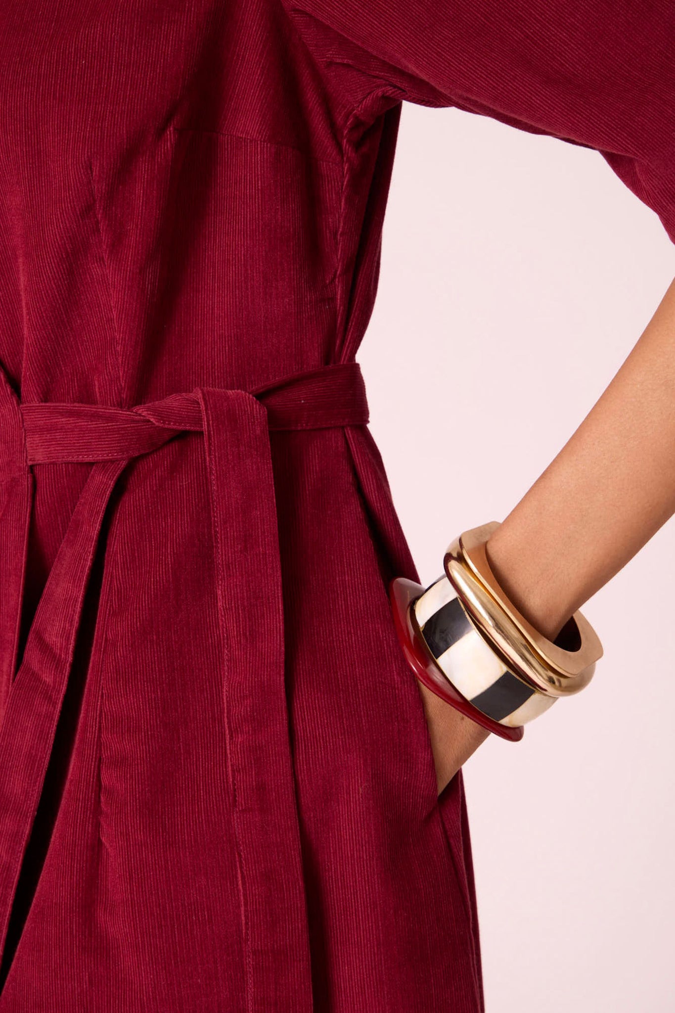 Cherry needlecord wrap dress with elbow-length sleeves, self-tie waist, and in-seam pockets.
