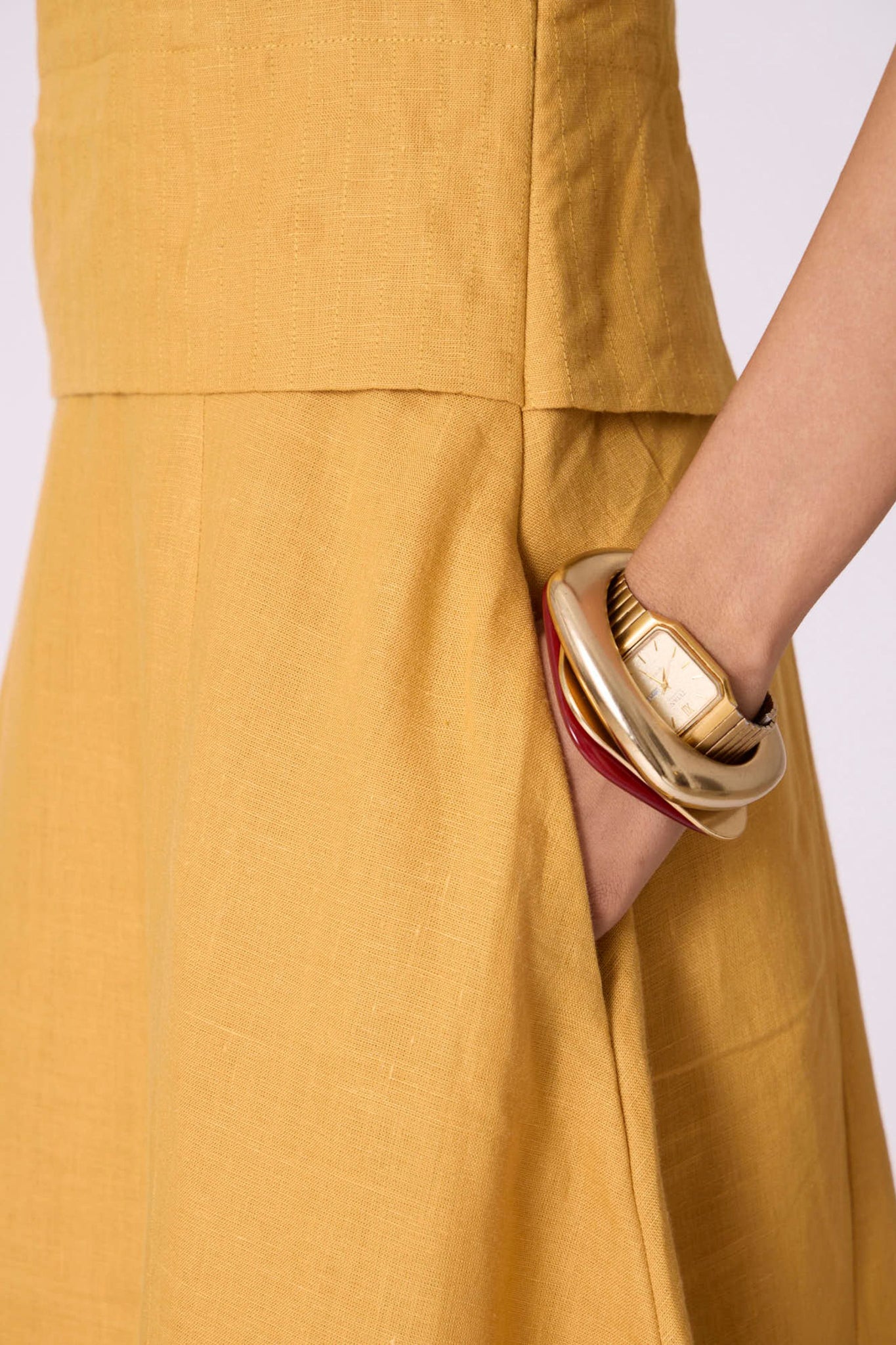 Yellow linen panelled dress with quilted low-waist yoke, paneled hemline, full lining, and in-seam pockets.